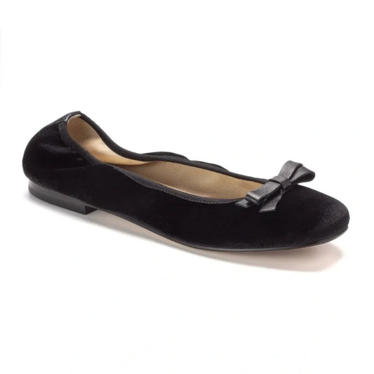 Girl wearing black velvet flats by London Kids