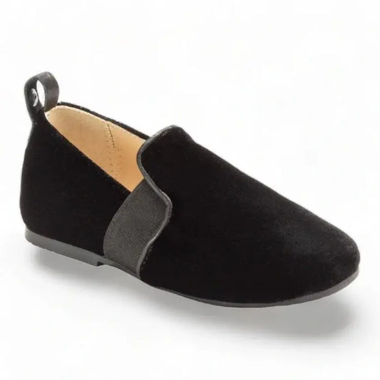 Black velvet slip-on shoes for boys by Manuela de Juan, perfect for formal occasions or everyday wear.